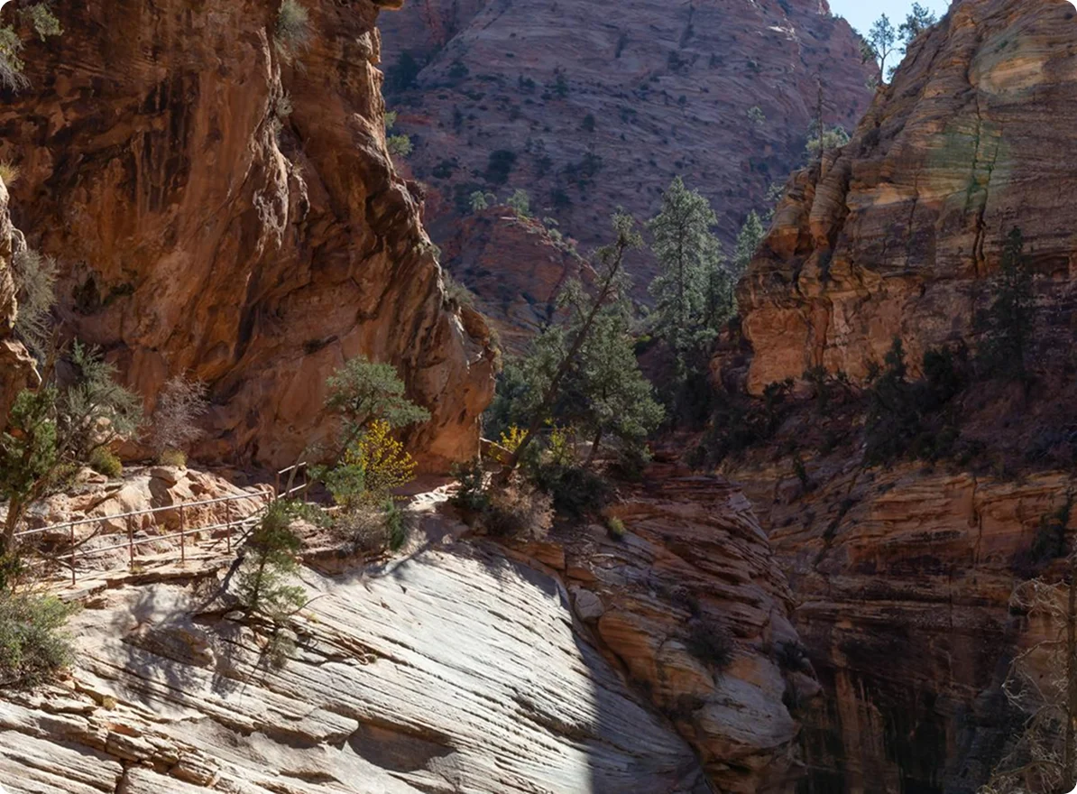 Red rock canyon walls and smooth slickrock in Aravaipa Canyon